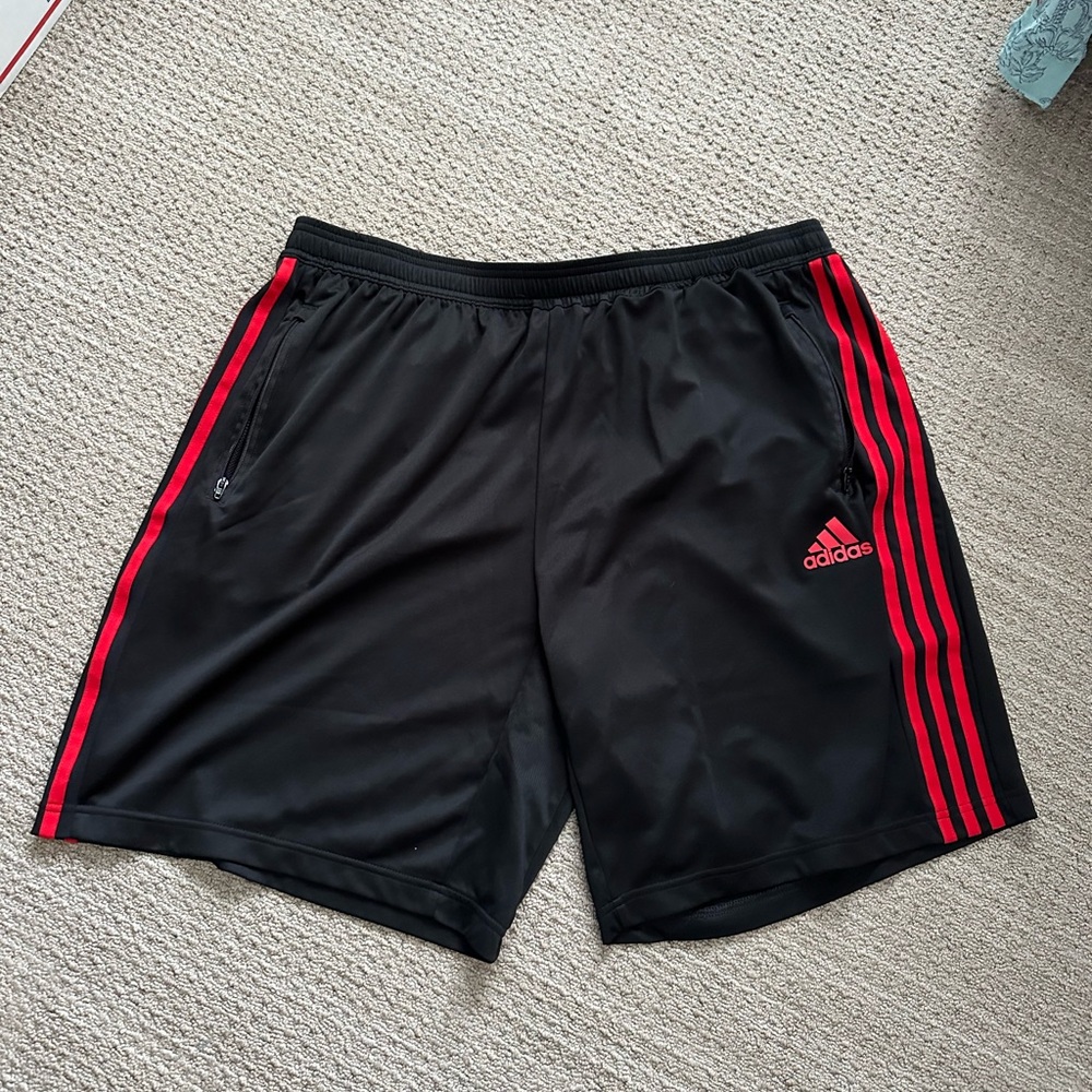 #238 Adidas Men's Black Shorts with Red Stripes in Size 2XL.
